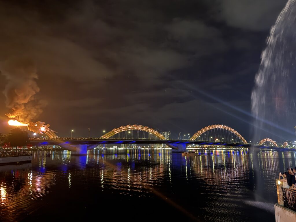 Fire and water show at Dragon Bridge in Da Nang, captured from the riverside walkway at night