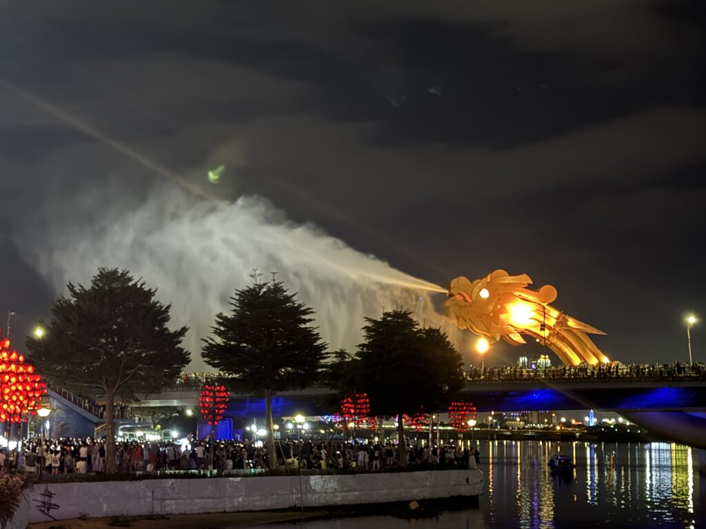 Water spraying from the mouth of Dragon Bridge during the night show in Da Nang