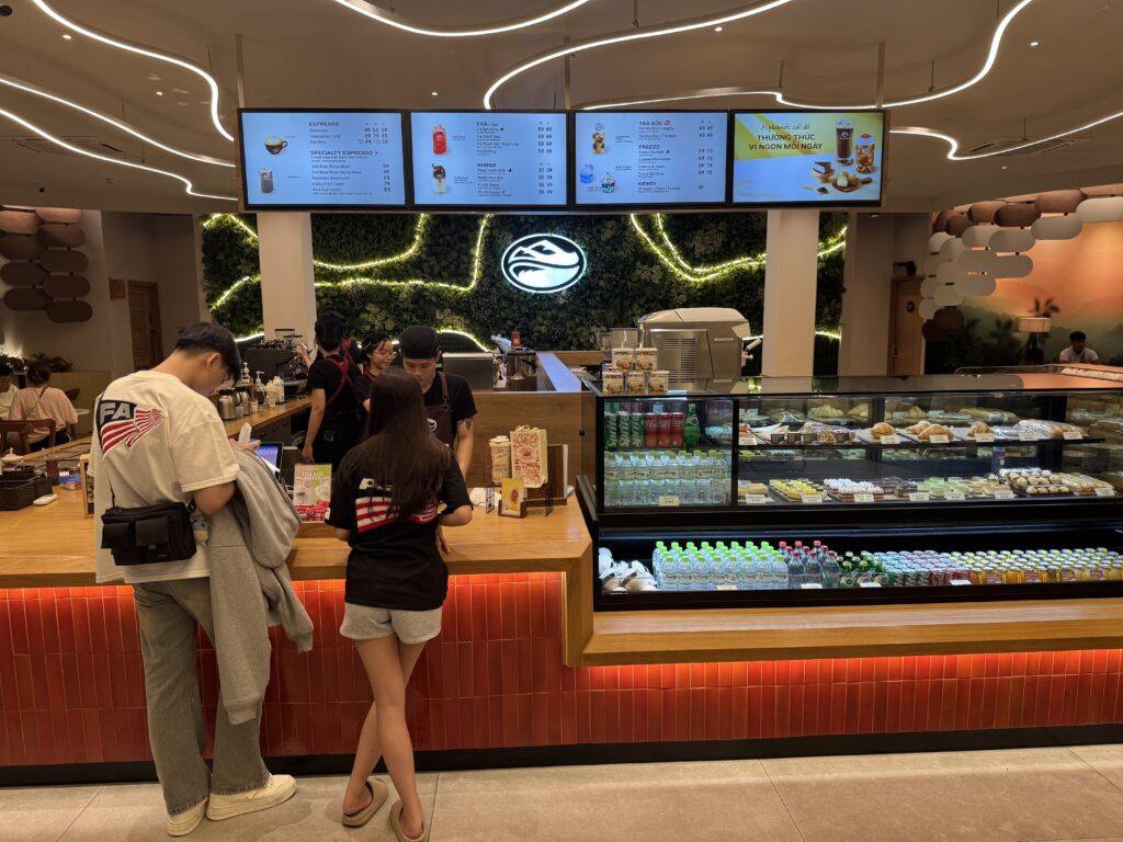 Customers ordering at the counter of Highlands Coffee