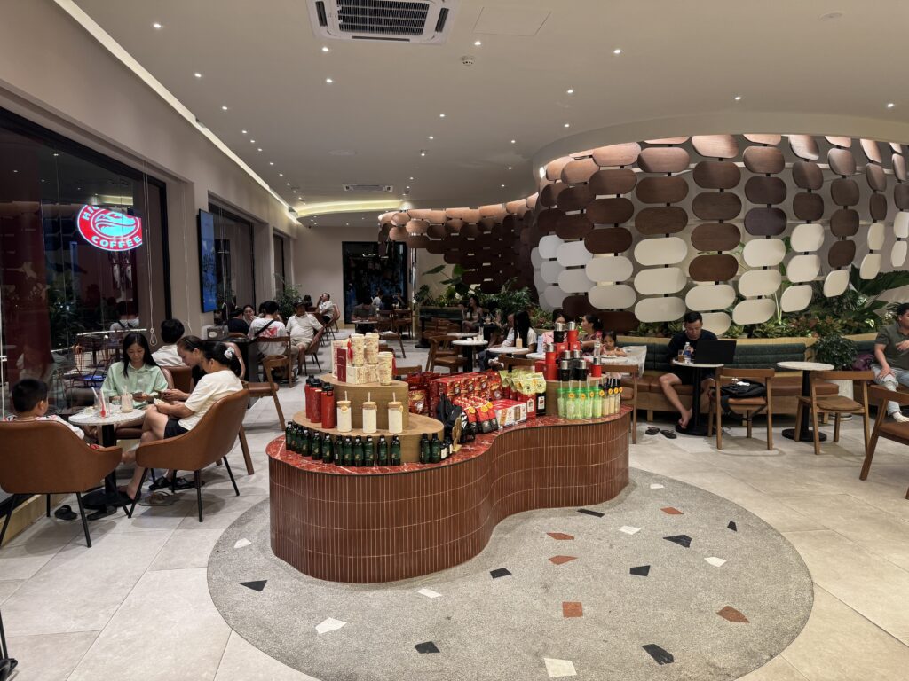 Highlands Coffee interior with colorful decor and display table