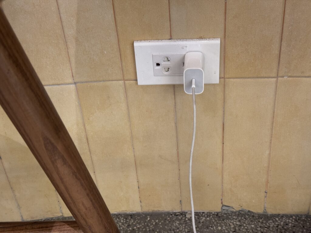 Power outlet with a charging cable at Highlands Coffee