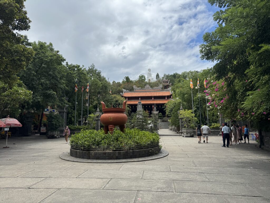 Courtyard of Long Son Pagoda with Buddha statue visible in the background