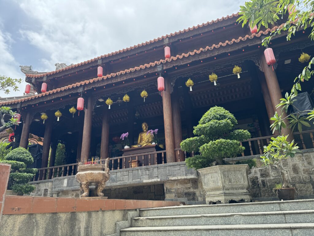 Golden Buddha statue inside the main hall of Long Son Pagoda